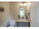 Half bathroom features granite countertop and bronze fixtures at 6270 Lancaster Pl, Zionsville, IN 46077