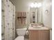 Bathroom featuring a toilet, sink vanity and shower with flower-themed curtain at 6270 Lancaster Pl, Zionsville, IN 46077