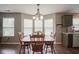 Bay window brightens the dining room, which has hardwood floors and wood table at 6270 Lancaster Pl, Zionsville, IN 46077