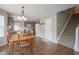 Cozy dining area with hardwood floors, wooden table, and a seamless flow into the kitchen at 6270 Lancaster Pl, Zionsville, IN 46077