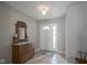 Welcoming entryway with tile floors, a charming wooden dresser, and a view of the front door at 6270 Lancaster Pl, Zionsville, IN 46077