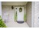 Inviting covered front porch with brick accent, rocking chair, and decorative wreath on the front door at 6270 Lancaster Pl, Zionsville, IN 46077