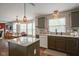 Open floor plan showing the dining room adjacent to a kitchen with an island and granite countertops at 6270 Lancaster Pl, Zionsville, IN 46077
