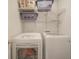 Laundry room area with white washer and dryer units, wire shelves and laundry baskets at 6270 Lancaster Pl, Zionsville, IN 46077