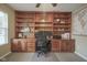 Spacious office features built-in bookshelves and cabinets for ample storage space at 6270 Lancaster Pl, Zionsville, IN 46077