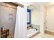 Bathroom featuring a tiled shower with seat, large soaking tub and unique tiled window at 6340 W 800 S, Pendleton, IN 46064