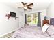 Cozy bedroom featuring a television, bright windows and patterned bedding at 6340 W 800 S, Pendleton, IN 46064