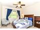 Comfortable bedroom featuring a ceiling fan, a bright window view, and nautical themed decor at 6340 W 800 S, Pendleton, IN 46064
