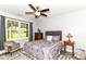 Bright bedroom with a ceiling fan, patterned bedding, and outside views at 6340 W 800 S, Pendleton, IN 46064