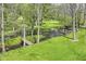 Picturesque creek with lush greenery and charming bridge, offering a peaceful and natural setting at 6340 W 800 S, Pendleton, IN 46064