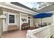Outdoor deck featuring a porch swing, table, chairs, grill, and a blue umbrella at 6340 W 800 S, Pendleton, IN 46064
