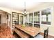 Well-lit dining room featuring a wooden table with bench seating and adjacent living spaces at 6340 W 800 S, Pendleton, IN 46064