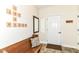 Inviting entryway with wood bench, Scrabble decor, mirror and door to the house at 6340 W 800 S, Pendleton, IN 46064