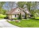 Attractive home featuring stone details, attached garage, and verdant landscaping at 6340 W 800 S, Pendleton, IN 46064
