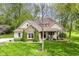 Inviting home exterior featuring stone accents, meticulous landscaping, and lush lawn at 6340 W 800 S, Pendleton, IN 46064