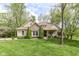 Beautiful home featuring stone accents, mature evergreens, manicured lawn, and inviting porch at 6340 W 800 S, Pendleton, IN 46064