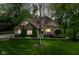 Beautiful home with stone accents, a well-kept lawn, and mature trees at twilight at 6340 W 800 S, Pendleton, IN 46064