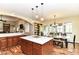 Open kitchen layout with an island, hardwood floors, and a view into the dining area at 6340 W 800 S, Pendleton, IN 46064