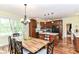 An open kitchen and dining area with island and a hardwood dining table at 6340 W 800 S, Pendleton, IN 46064