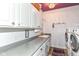 Functional laundry room with white cabinets, sink, and modern washer and dryer units at 6340 W 800 S, Pendleton, IN 46064