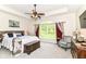 Comfortable main bedroom with a tray ceiling, ceiling fan, large window, and stylish furniture at 6340 W 800 S, Pendleton, IN 46064