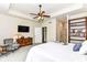 Well-lit main bedroom featuring a tray ceiling, en-suite bathroom, and comfortable sitting area at 6340 W 800 S, Pendleton, IN 46064
