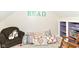 Reading nook with chair, decorative pillows, and a purple bookcase at 6340 W 800 S, Pendleton, IN 46064