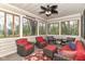 Enclosed porch with large windows, ceiling fan, and comfortable seating arrangement at 6340 W 800 S, Pendleton, IN 46064
