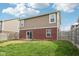 View of the backyard featuring a brick wall, sliding glass door and lawn at 6540 Mccreery Ct, Indianapolis, IN 46221