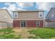 Backyard features a lawn, wood fence, brick wall and sliding glass door at 6540 Mccreery Ct, Indianapolis, IN 46221