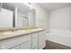 Bathroom featuring double sinks, tub, and plank flooring at 6540 Mccreery Ct, Indianapolis, IN 46221