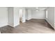 Open bedroom and bath area boasts wood-look floors, a ceiling fan, and natural light at 6540 Mccreery Ct, Indianapolis, IN 46221