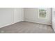 Bedroom featuring neutral walls, gray carpet, a window, and a closet at 6540 Mccreery Ct, Indianapolis, IN 46221