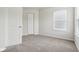 This is a bedroom with light gray carpet, a window, and white trim at 6540 Mccreery Ct, Indianapolis, IN 46221