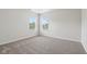 The bedroom has neutral walls and carpet, two windows, and great natural light at 6540 Mccreery Ct, Indianapolis, IN 46221