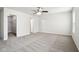 Large bedroom with gray carpet, ceiling fan, walk-in closet, and white trim at 6540 Mccreery Ct, Indianapolis, IN 46221