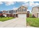Attractive two-story home showcasing a long driveway, well-maintained lawn, and classic architectural details at 6540 Mccreery Ct, Indianapolis, IN 46221