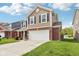 Charming two-story home with brick accents, a two-car garage, and a neatly landscaped front yard at 6540 Mccreery Ct, Indianapolis, IN 46221