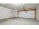Spacious two-car garage featuring concrete flooring and an automatic door opener at 6540 Mccreery Ct, Indianapolis, IN 46221