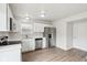 Stylish kitchen featuring stainless steel appliances, white cabinets, and wood-look floors at 6540 Mccreery Ct, Indianapolis, IN 46221
