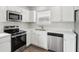 Modern kitchen with stainless steel appliances and white cabinets at 6540 Mccreery Ct, Indianapolis, IN 46221