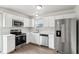 Bright kitchen features stainless steel appliances and white cabinets at 6540 Mccreery Ct, Indianapolis, IN 46221