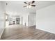 Open-concept space featuring wood-look flooring flows to kitchen with stainless appliances and white cabinetry at 6540 Mccreery Ct, Indianapolis, IN 46221