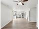 Open-concept living space with wood-look flooring leads to a kitchen and bedroom at 6540 Mccreery Ct, Indianapolis, IN 46221