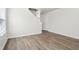 Inviting living area with new vinyl plank flooring, offering a view of the staircase at 6540 Mccreery Ct, Indianapolis, IN 46221