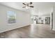Open-concept living space with wood-look flooring flows into a kitchen with stainless steel appliances at 6540 Mccreery Ct, Indianapolis, IN 46221