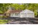 Charming ranch home featuring brick and white siding, an attached two-car garage and mature trees at 728 E Main St, Carmel, IN 46032