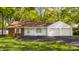 Charming ranch home featuring brick and white siding, an attached two-car garage and mature trees at 728 E Main St, Carmel, IN 46032