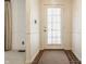Foyer with neutral walls and a windowed front door, offering natural light and a welcoming entrance at 728 E Main St, Carmel, IN 46032