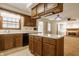 Kitchen featuring wood cabinets, laminate countertops, an island and black appliances at 728 E Main St, Carmel, IN 46032